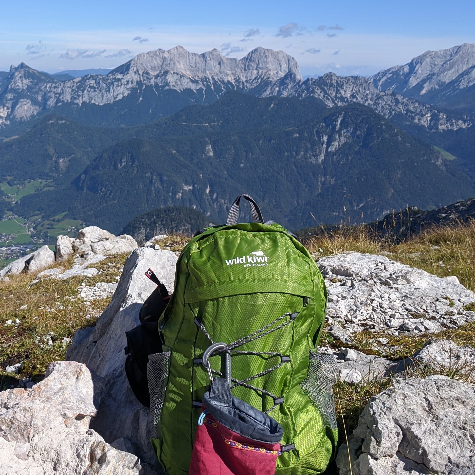 Green packable Wild Kiwi backpack, in Austrian Alps