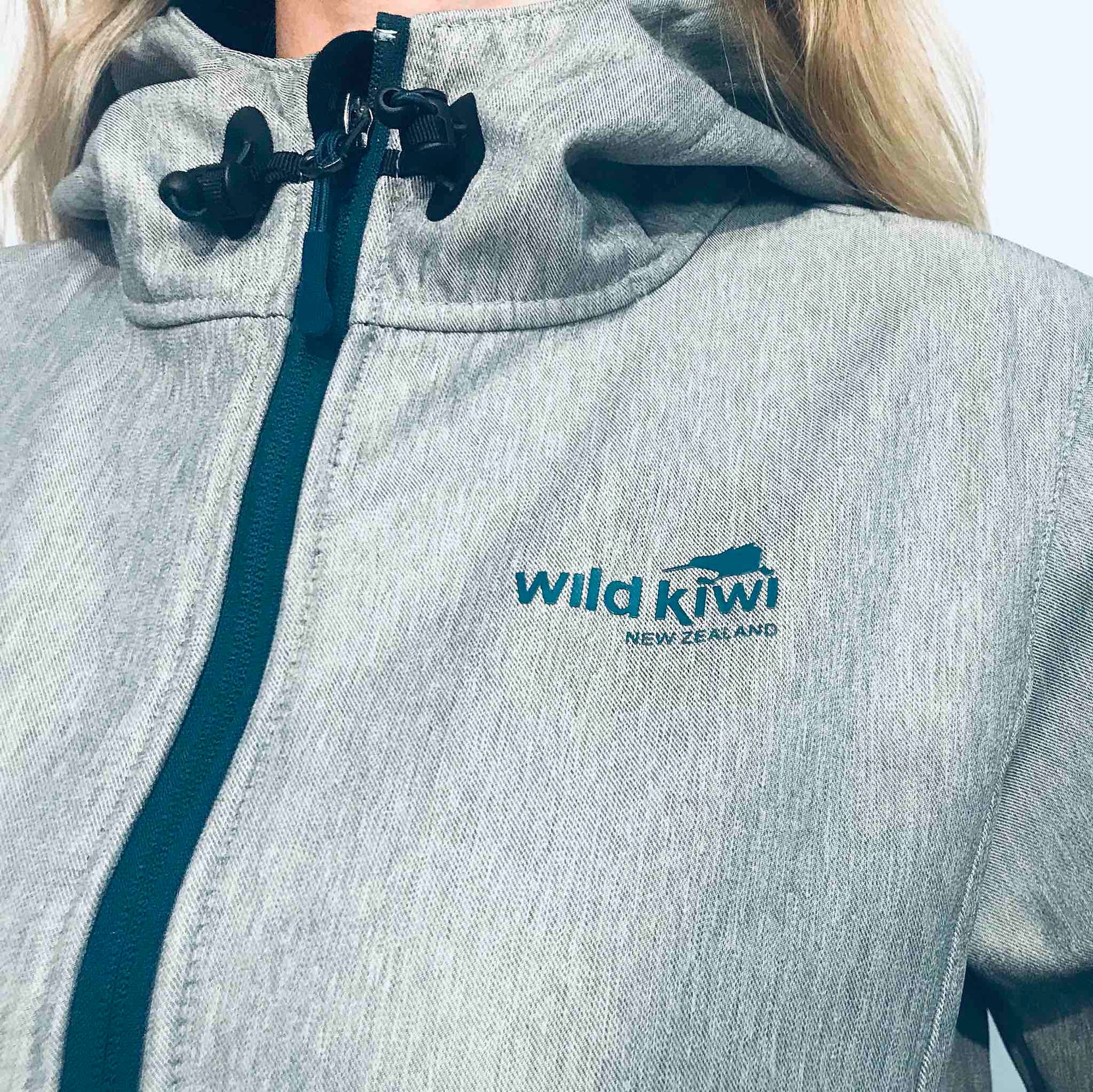 Women&#39;s grey hooded soft shell jacket with blue lining and zips. Water resistant tech shell. www.wild-kiwi.co.nz